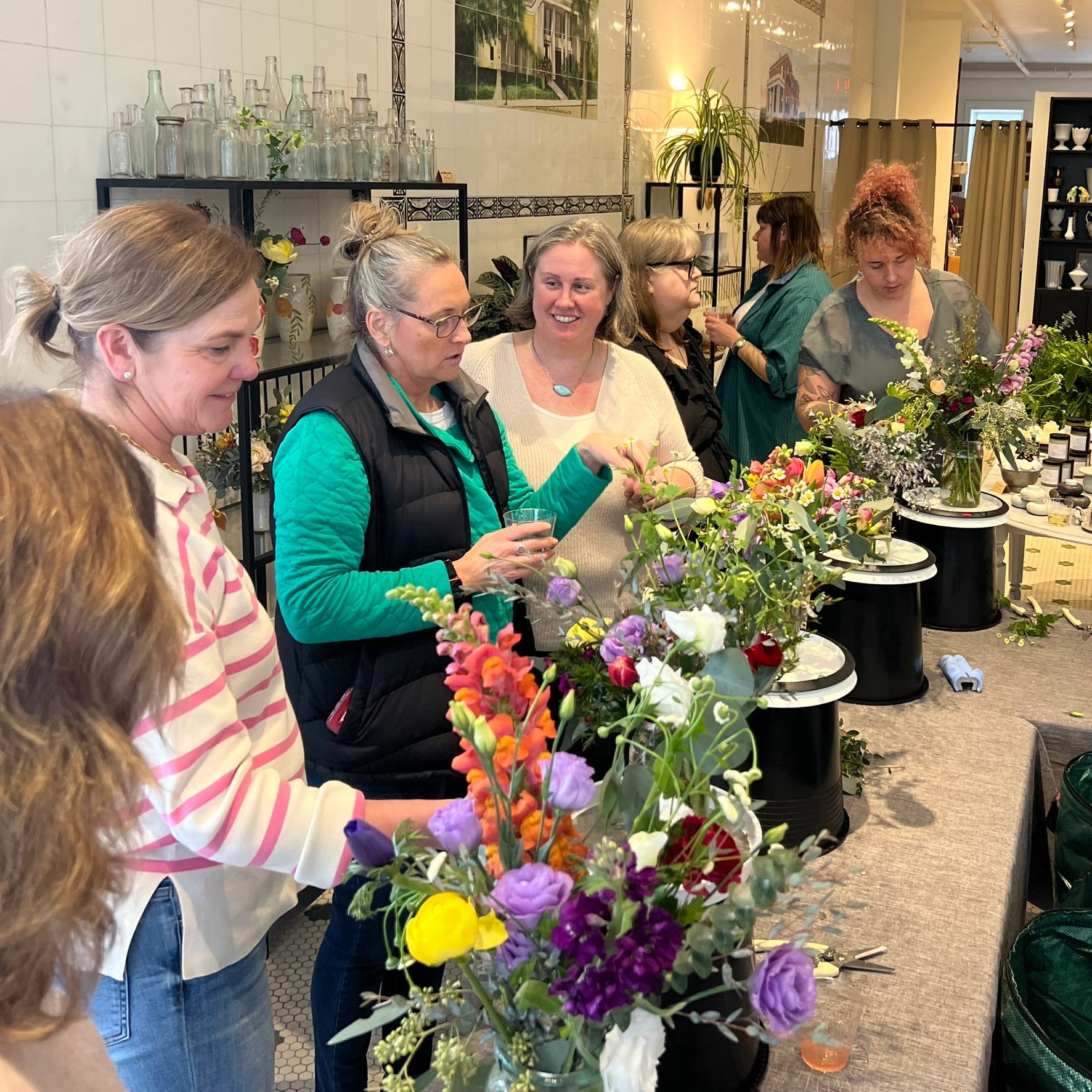 women arranging flowers together